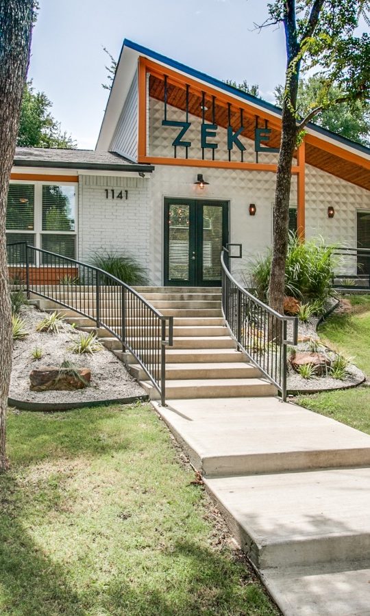 a home with a large yard and a walkway at The Zeke