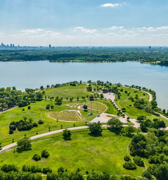 an aerial view of a park and lake at The Zeke