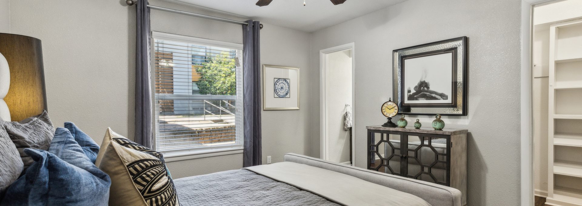 a bedroom with a ceiling fan and hardwood floors at The Zeke