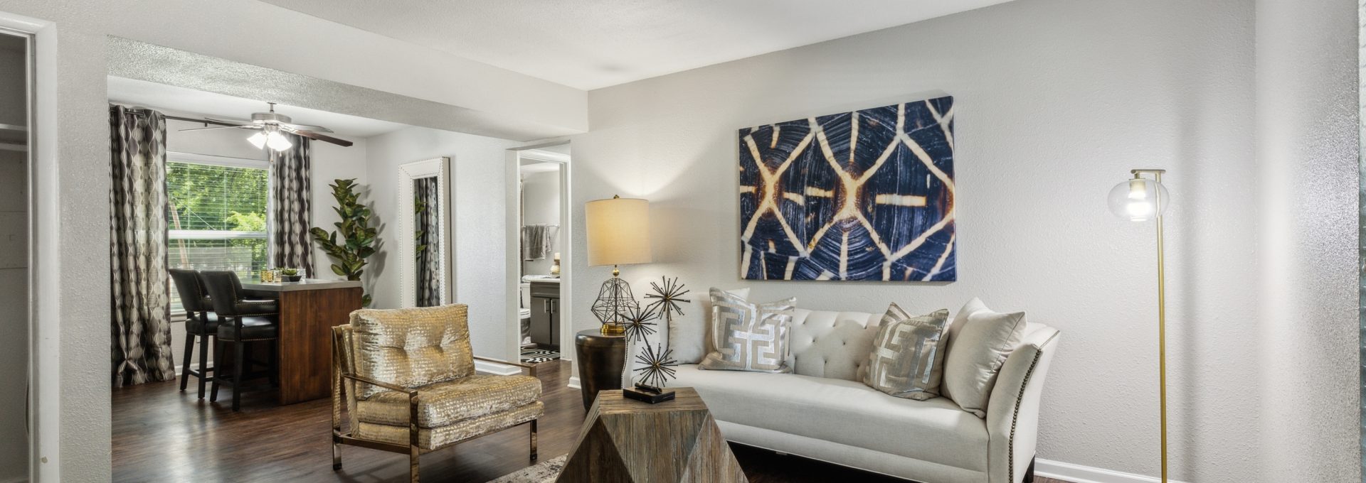 a living room with hardwood floors and a large picture window at The Zeke