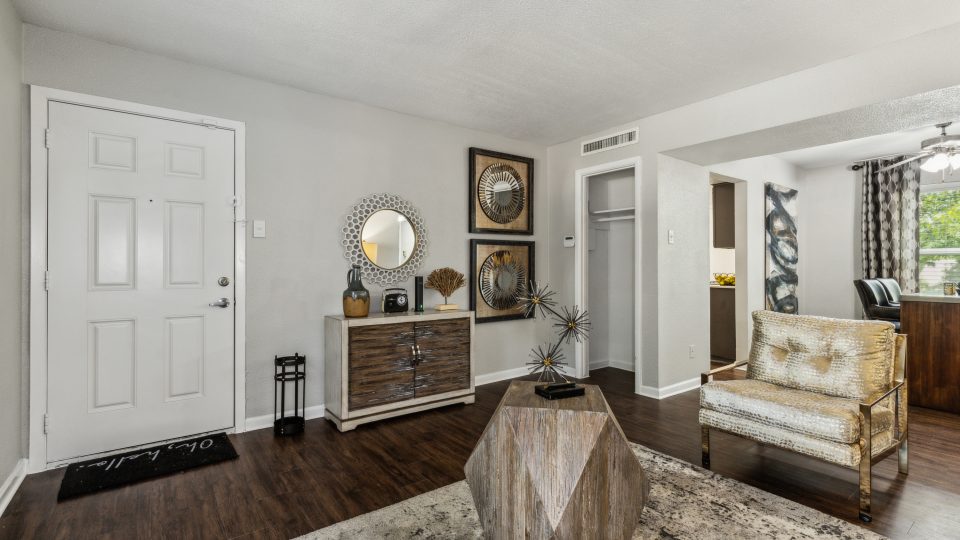 a living room with hardwood floors and a white couch at The Zeke